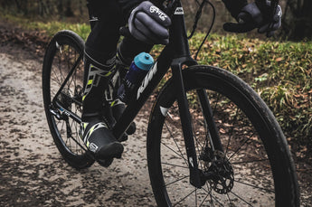 Close-up of a black KTM bicycle frame with a water bottle and detailed components.